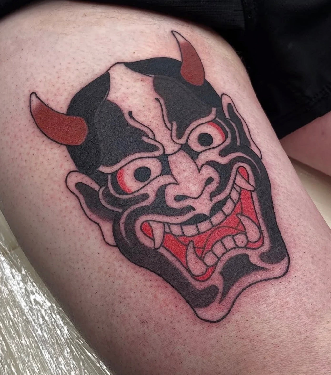 Small traditional Japanese oni mask tattoo