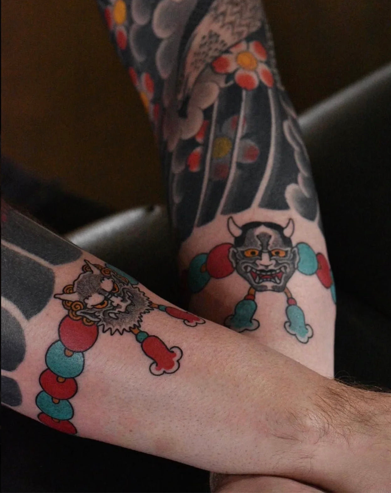 Small traditional Japanese mask and bead tattoos